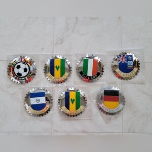 Seven Car Grille Emblem Badges Six used & One New They all have marks from use